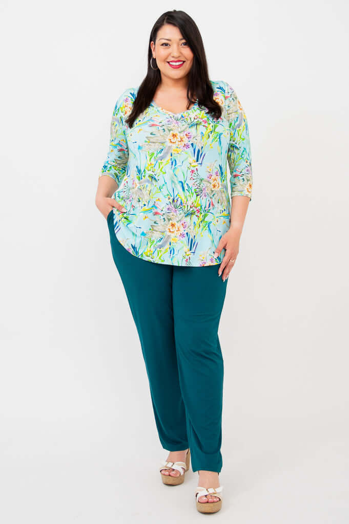 Model posing in Jackie V-Neck Bamboo Top Spring Meadow with hands in pockets