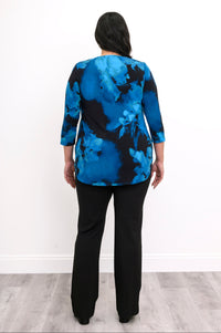 Rear view of an indigo patterned A-line tunic blouse highlighting the fluid hem and full hip coverage.