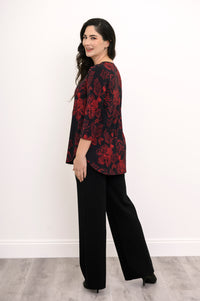 Back view of a red and black floral print bamboo top, illustrating a loose, hip-covering length and rounded hem.