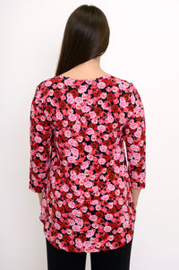 Back view of a red and pink floral print bamboo top, highlighting the relaxed-fit drape and curved hemline.