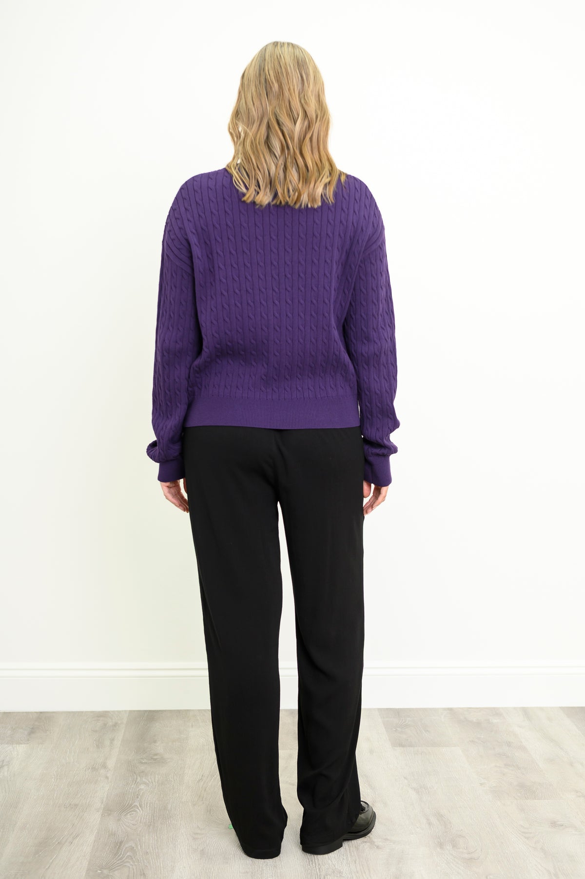 Rear view of a textured plum cotton pullover, highlighting its classic fit and comfortable mid-hip length.