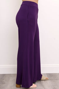 Side portrait of a women's monochrome royale purple bamboo knit pant look.