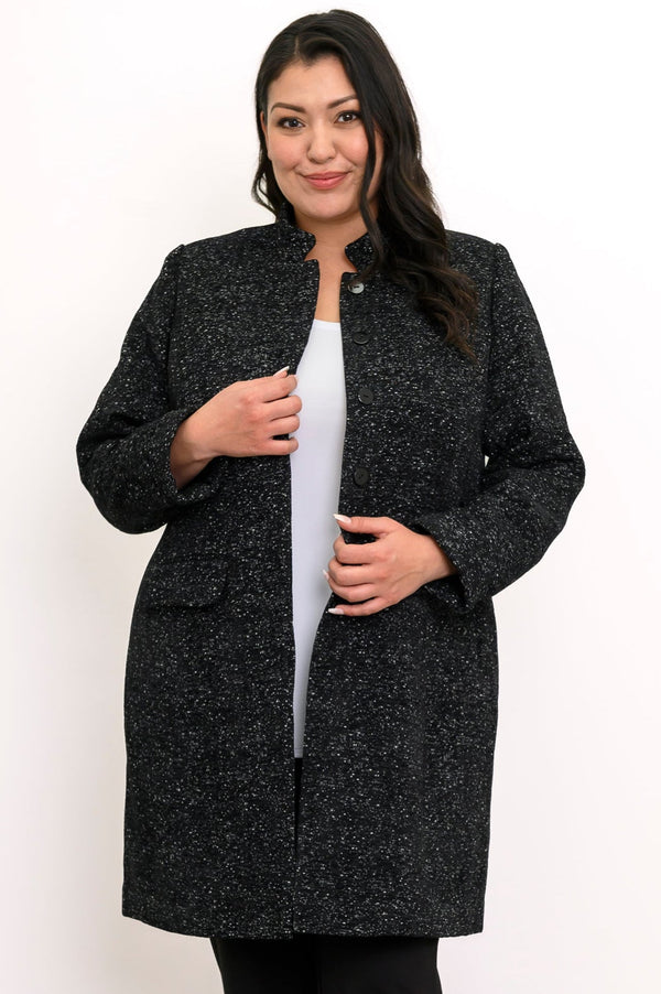 Woman wearing black textured coat with pockets and black pants on a white background, front view