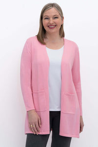 Front view of woman wearing pink open cardigan with patch pockets