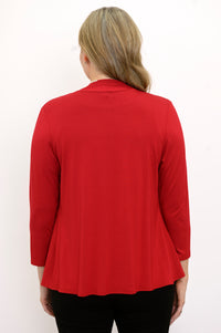 Back view of woman wearing a red cardigan, black top, and black pants on a white background