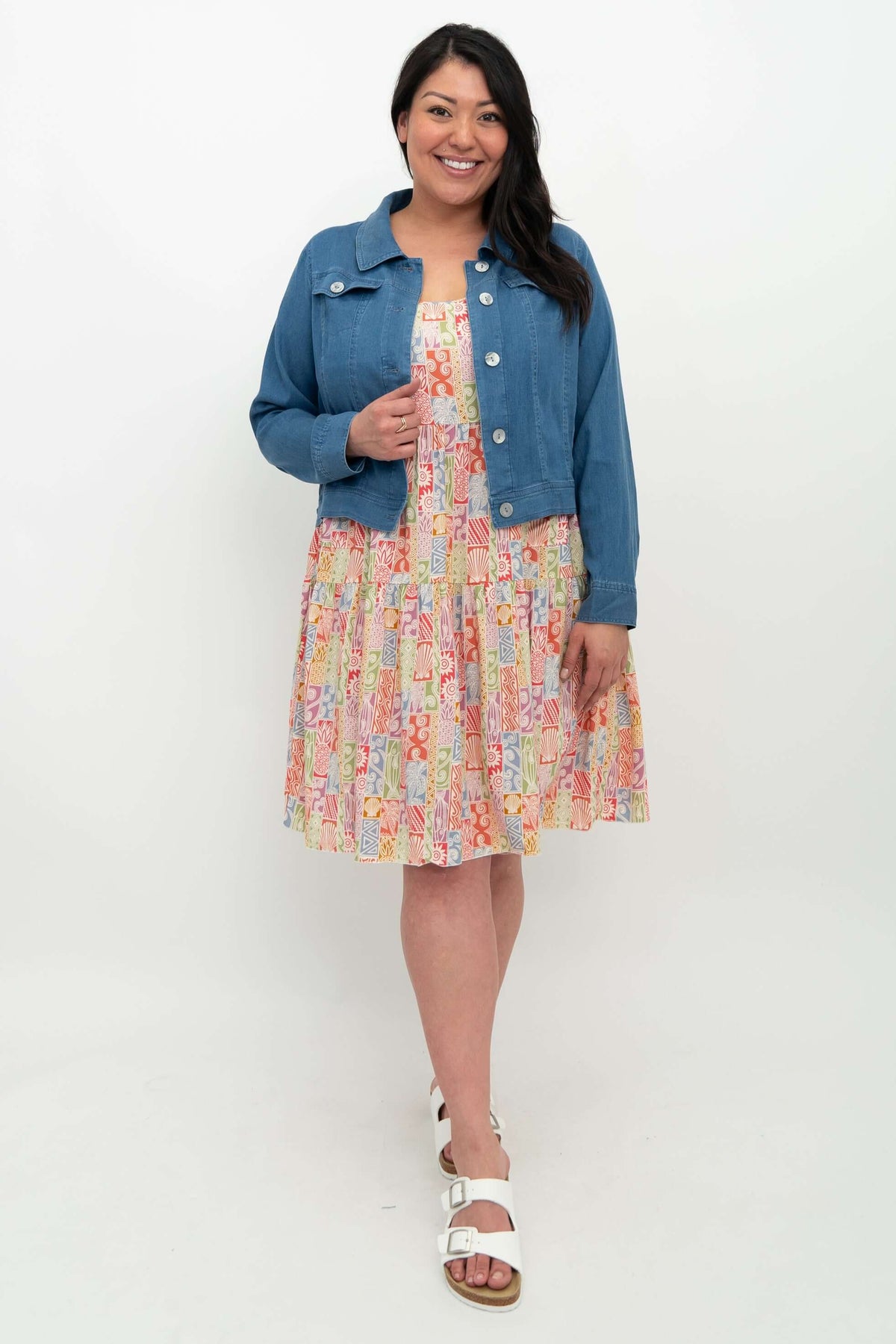 Model wearing Kayana dress with a blue denim jacket, front view