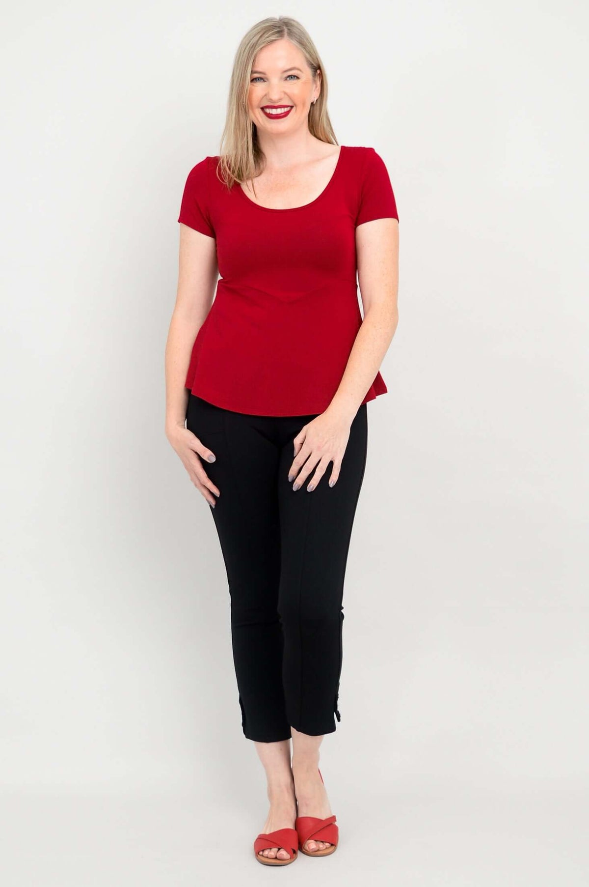 Woman modeling Kim Cap bamboo top in cherry red, standing straight