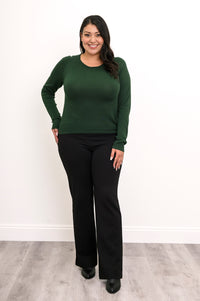 Front-facing view of a women's deep moss scoop neck knit top and dark pants, showcasing a classic autumn look.