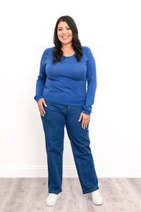 Front view of a loose-fit women's blue raglan sweater, showcasing a straight-cut hemline and relaxed silhouette.