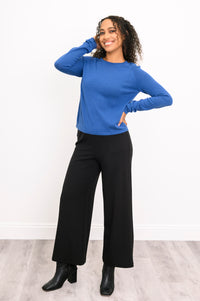 Vibrant blue long-sleeve cotton tunic top with flat-finished wrist cuffs, styled as an office casual outfit.