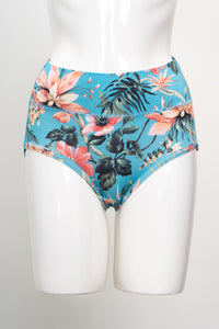 Tropical floral pattern brief underwear on a white mannequin torso, featuring a turquoise base with pink hibiscus.
