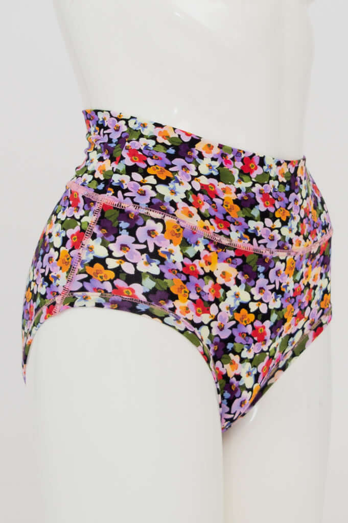 Side view of La Gaunche classic high-waist brief in vibrant floral pattern