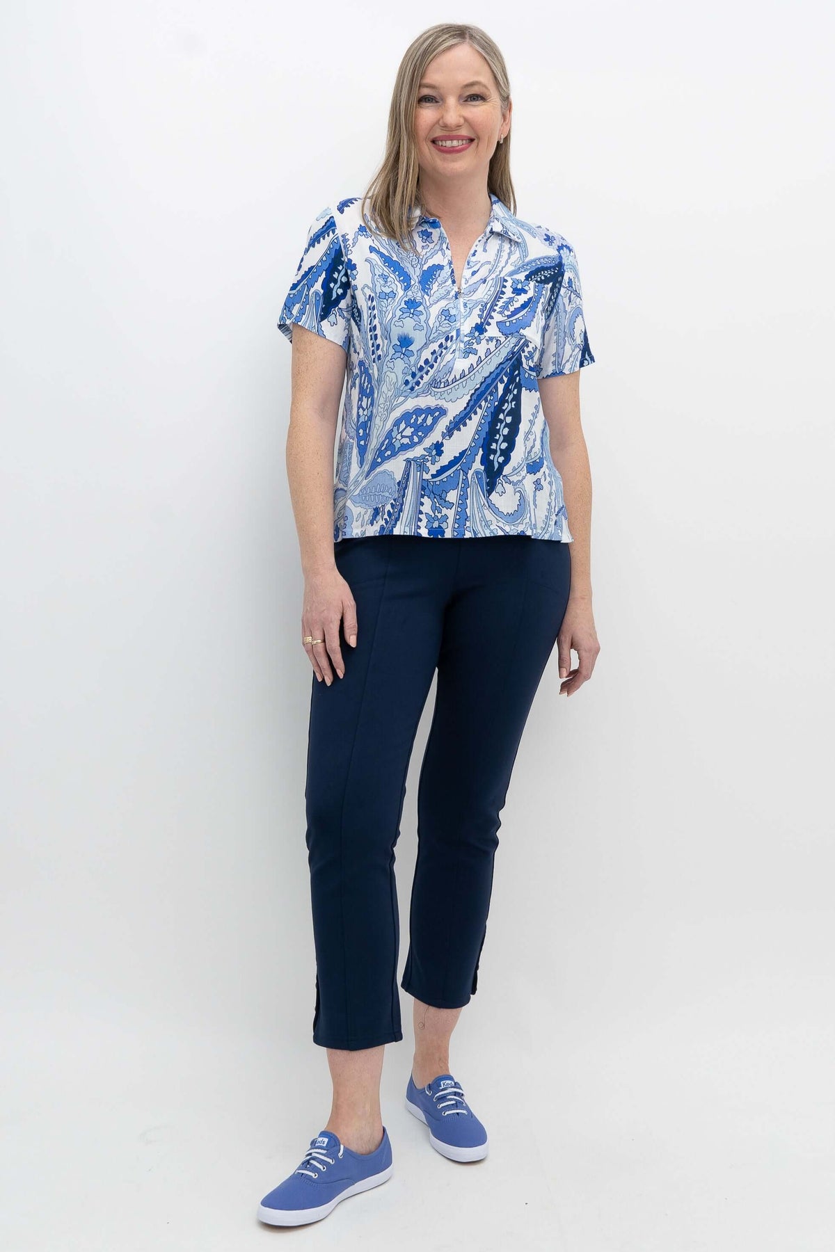 Full body view of model in Lala blue paisley zip top and navy pants