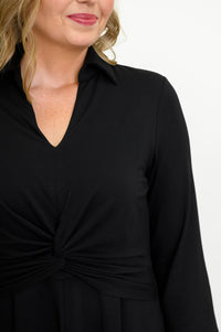 Close up view of woman wearing long black dress on a white background