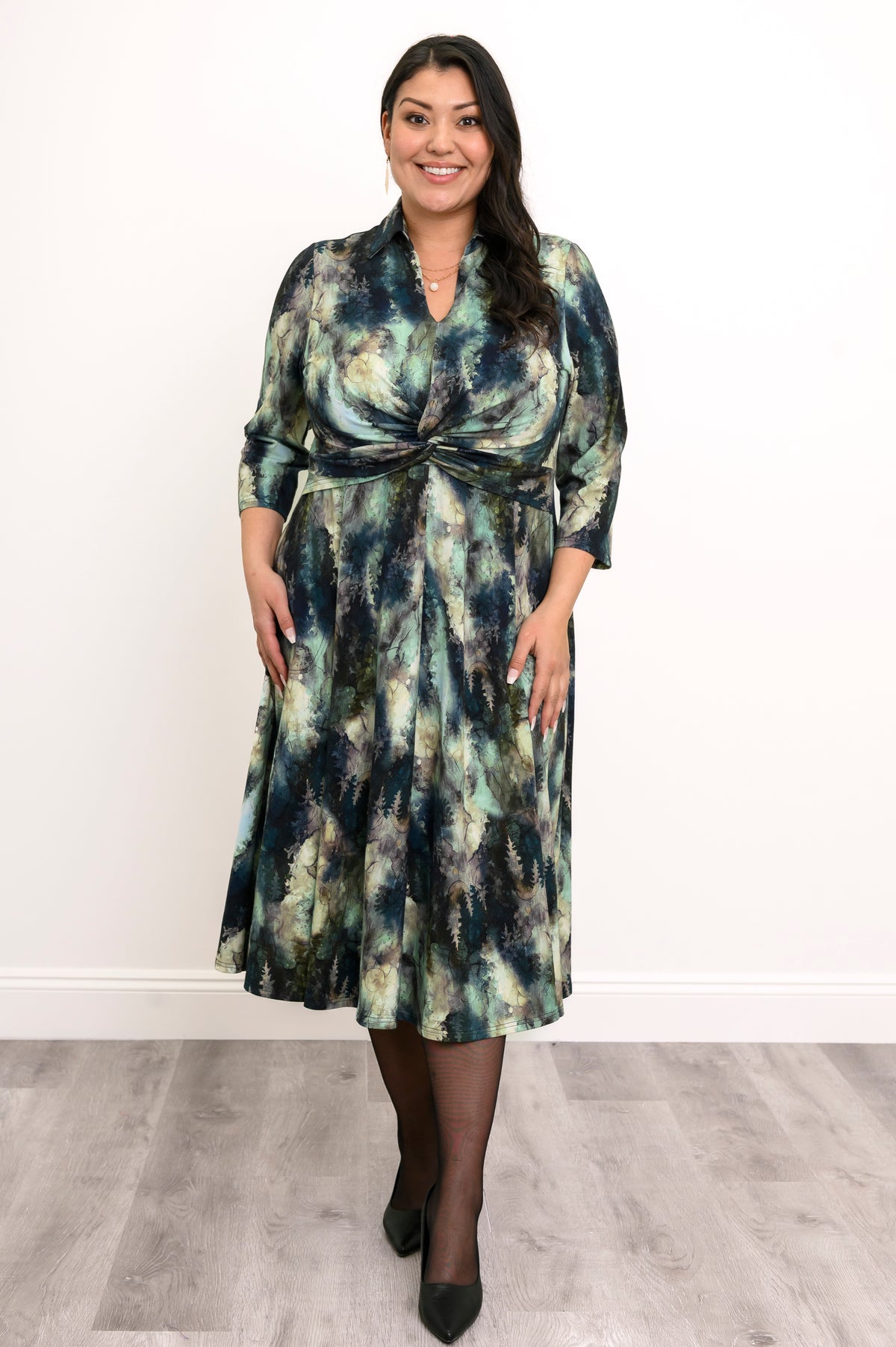 Flowy bamboo A-line dress featuring a shirt collar, V-neck, and defined high waist twist, shown in a front view.