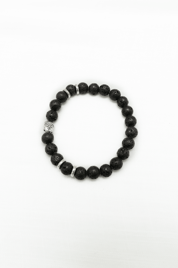 Black lava stone beaded bracelet with Buddha head and silver accents on white background