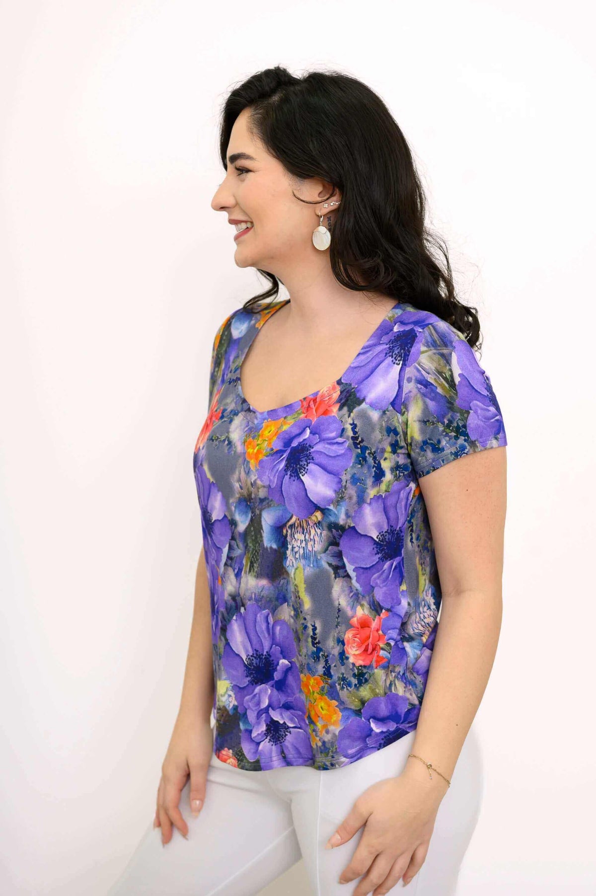 Left side profile of model in floral sweetheart neckline bamboo top