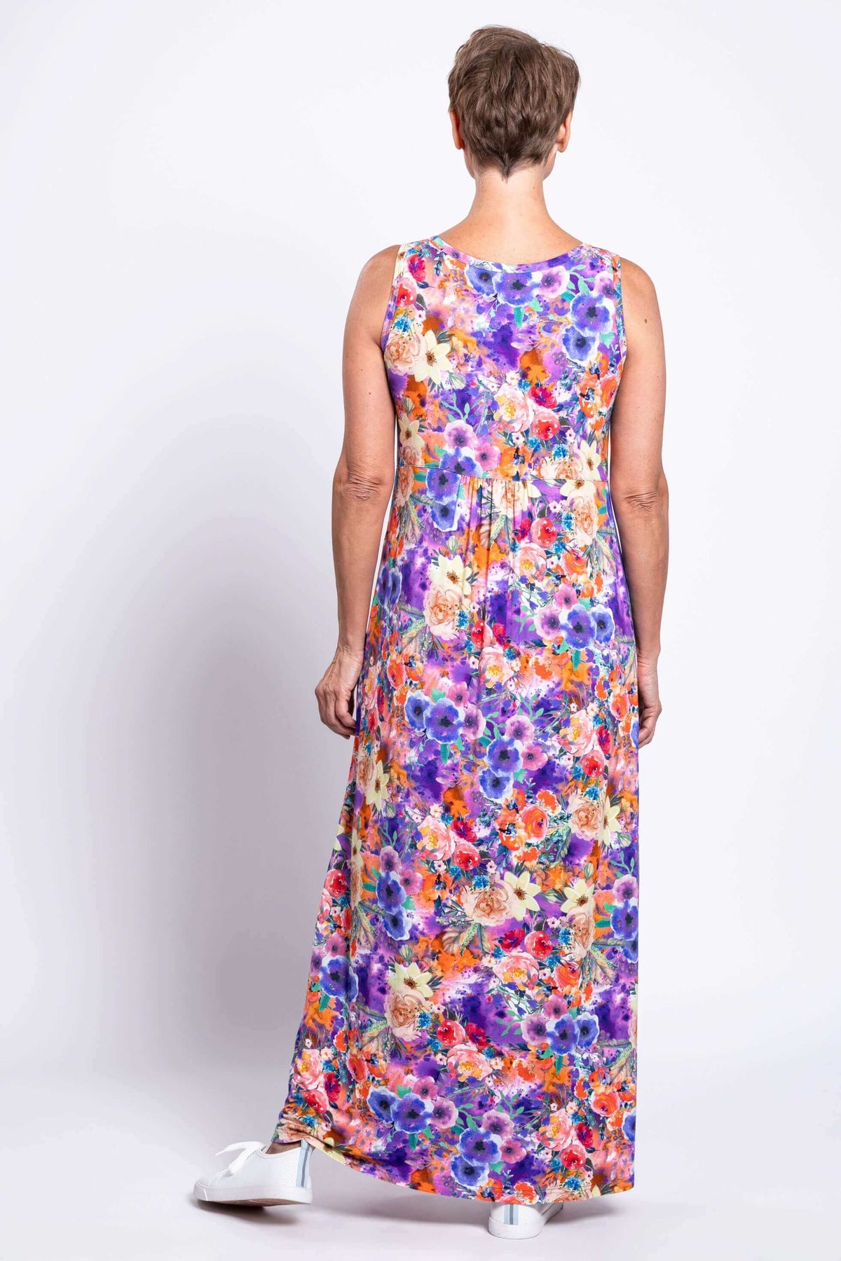Back view of woman wearing the same floral sleeveless maxi dress