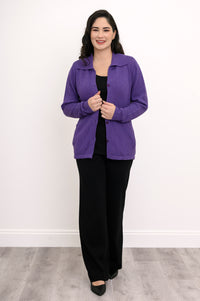 Model posing in a plum cotton cardigan layered over a simple black top, shown front-facing against a plain wall.