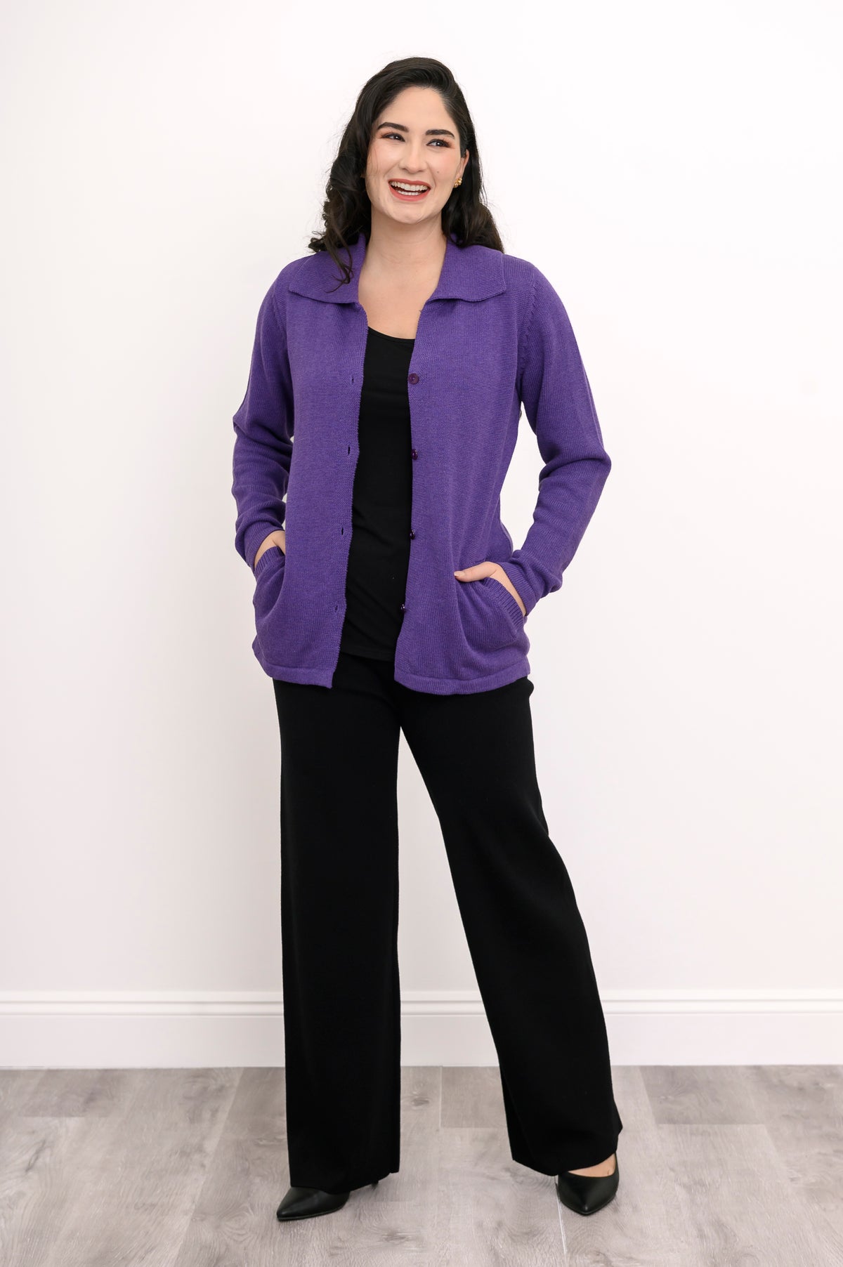Front view of a violet long-sleeve sweater jacket with a traditional collar, showing a casual weekend outfit.