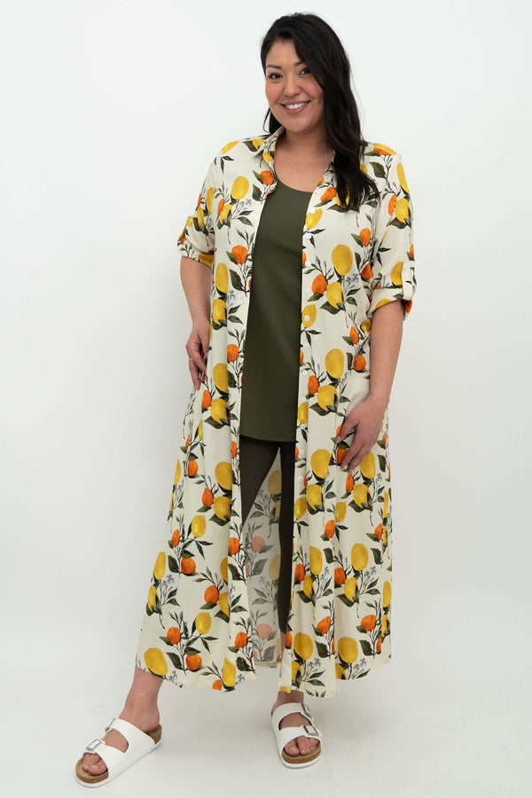 Woman wearing linen bamboo citrus maxi shirt dress open as a duster over green outfit