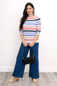 Model in Louisa Sweater holding a black purse, styled with blue jeans