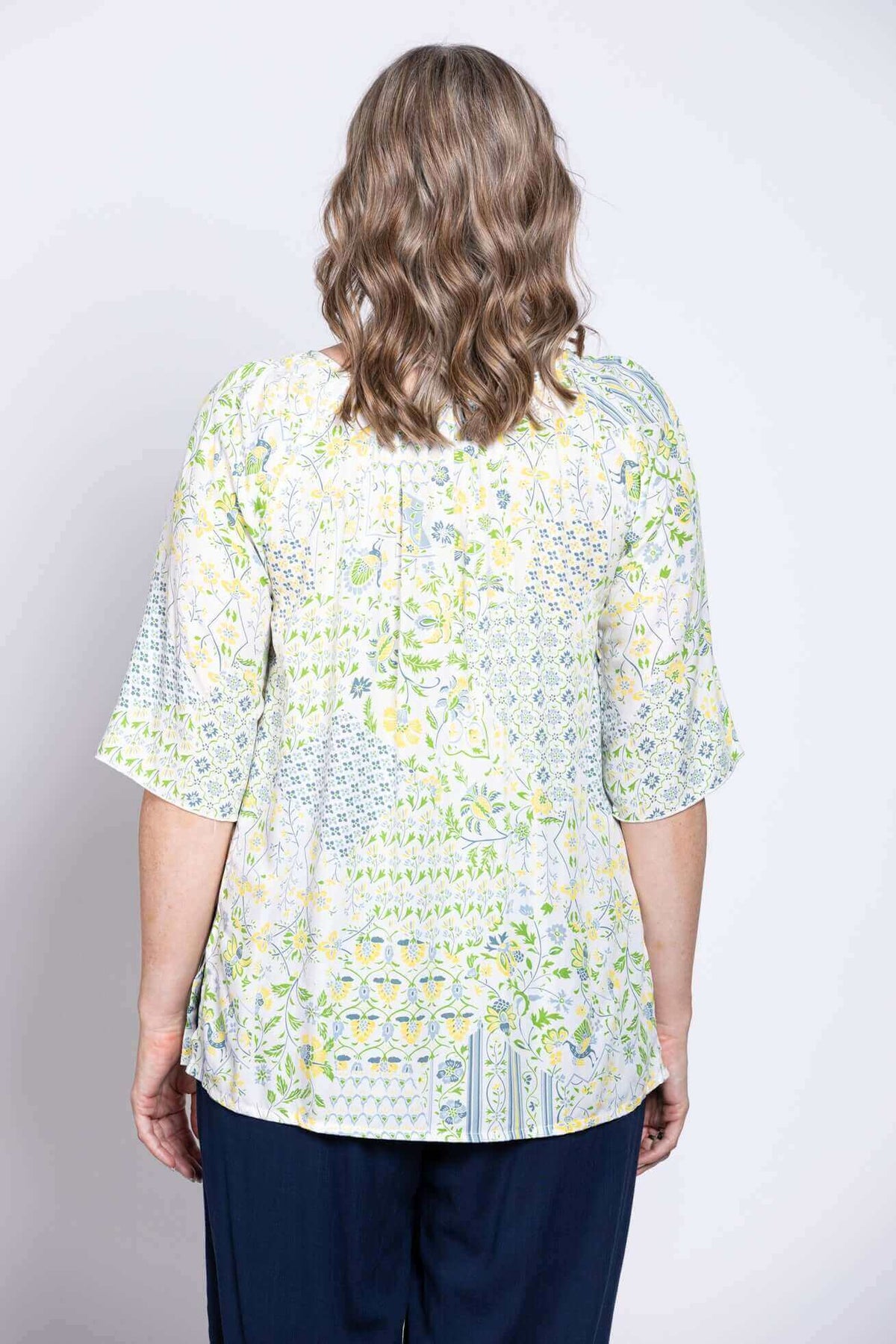 Back view of Luna Boho Peasant Top showing floral print and loose fit