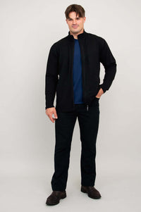 Man standing in black bamboo fleece jacket with hands in pockets