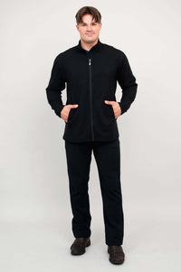 Man wearing black full-zip jacket, both hands in pockets