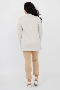Back view of woman wearing the Margaret beige cotton cardigan and beige pants
