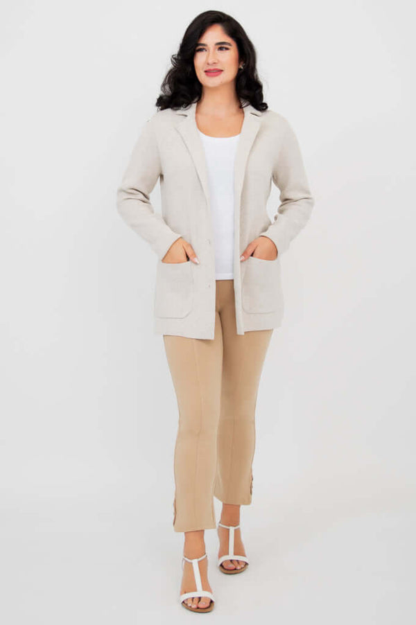 Full body front view of woman modeling the Margaret cardigan over white top and beige pants