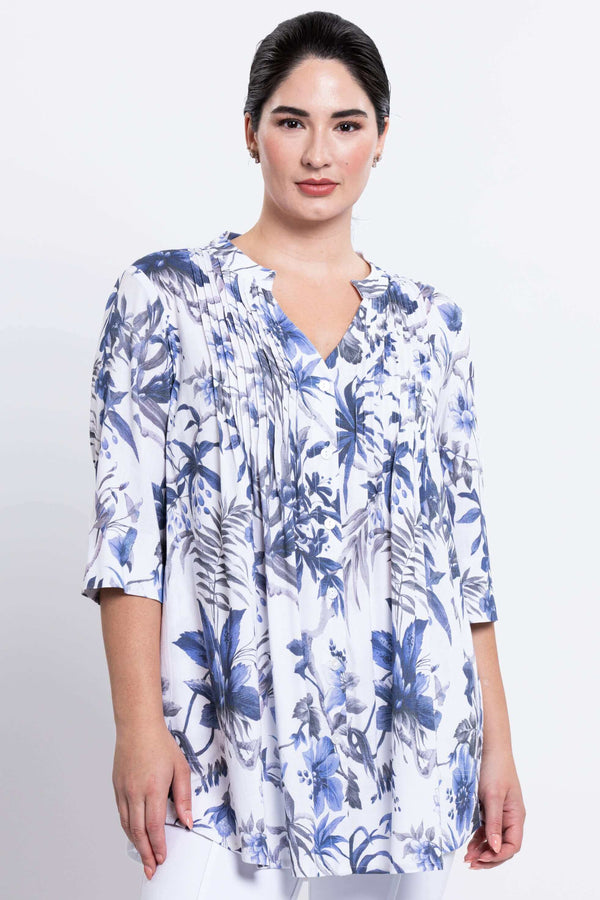 Front view of woman wearing Margate blouse in white with blue floral print and pin tucks