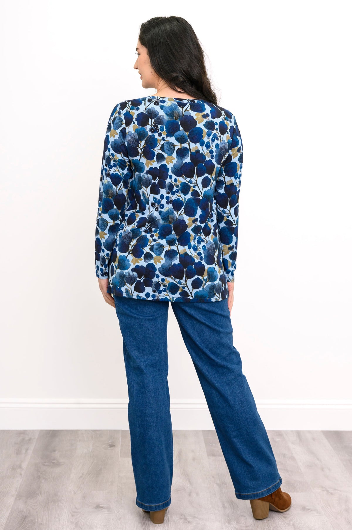 Rear view of an indigo patterned long sleeve tunic blouse with a straight-cut hemline.