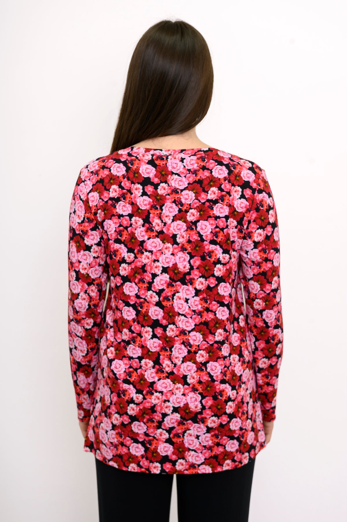 Back view of a pink and red floral print bamboo top, showcasing a relaxed-fit drape and straight-cut hemline.
