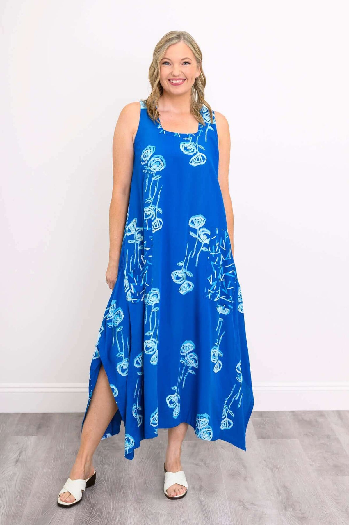Front view of woman wearing Maria Dress in blue with white botanical print
