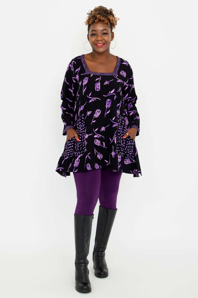 Full outfit view of Maria Tunic with violet rose print, paired with purple leggings and black boots