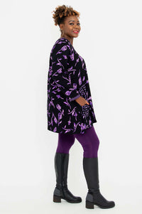 Side profile of Maria Tunic showing shark-bite hem and contrast patch pockets