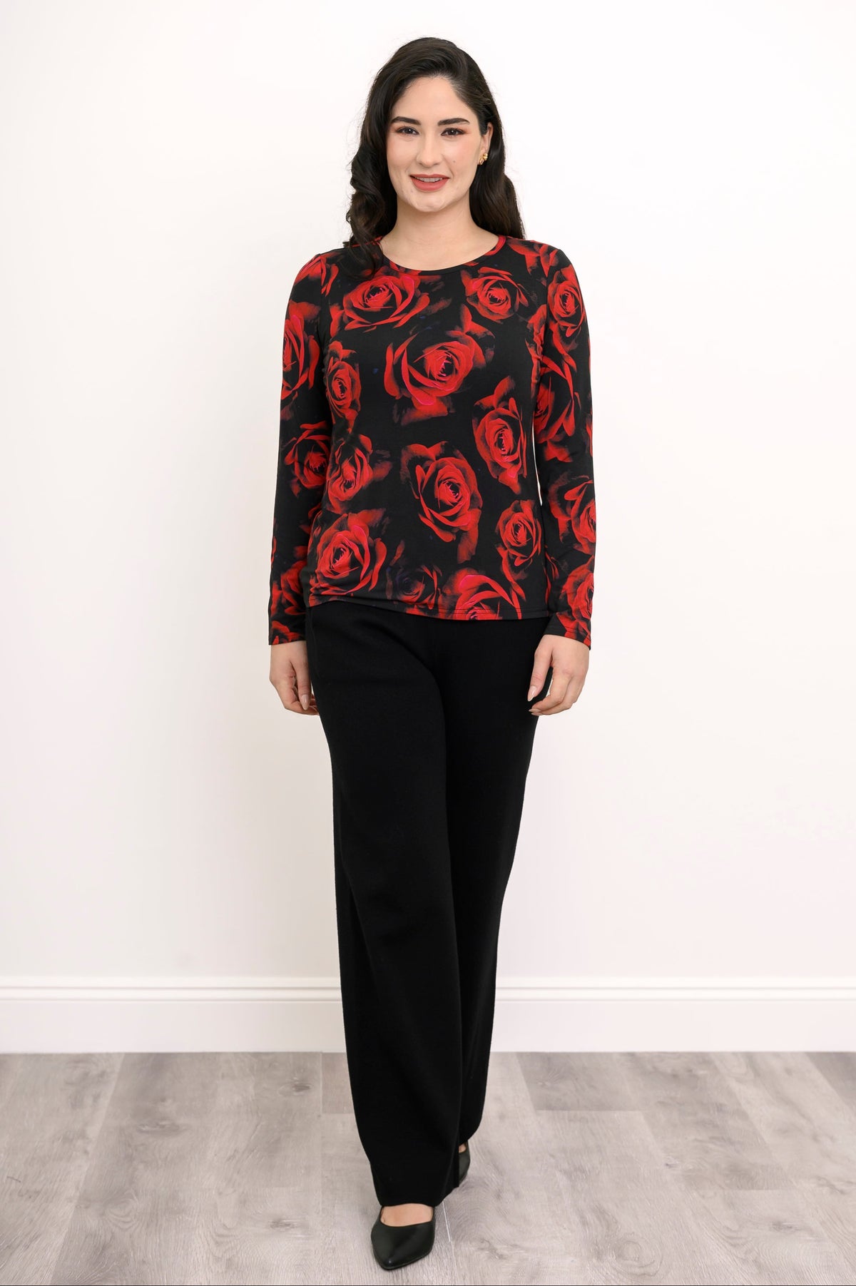 Model posing in a black and red floral print bamboo shirt paired with wide-leg black trousers, front view.