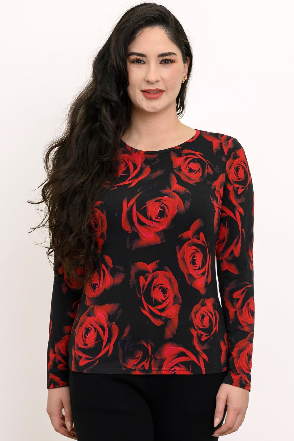 Smiling woman wearing a black long-sleeve knit tee with a high round collar and a vibrant scarlet rose pattern.