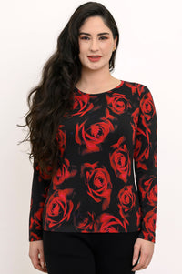 Smiling woman wearing a black long-sleeve knit tee with a high round collar and a vibrant scarlet rose pattern.
