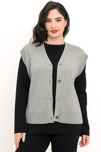 Smiling woman wearing a light gray fine-knit vest with a deep V-neckline and dark marled button closures.
