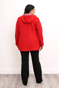 Back view of woman wearing bright red jacket showing red floral lining in the hood