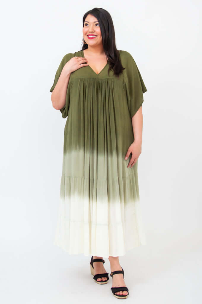 Woman in an olive ombre maxi dress looking upward, showing the dress's details