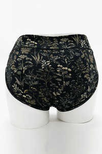 Back view of Meadow Black Hipster briefs featuring seamless design and botanical pattern