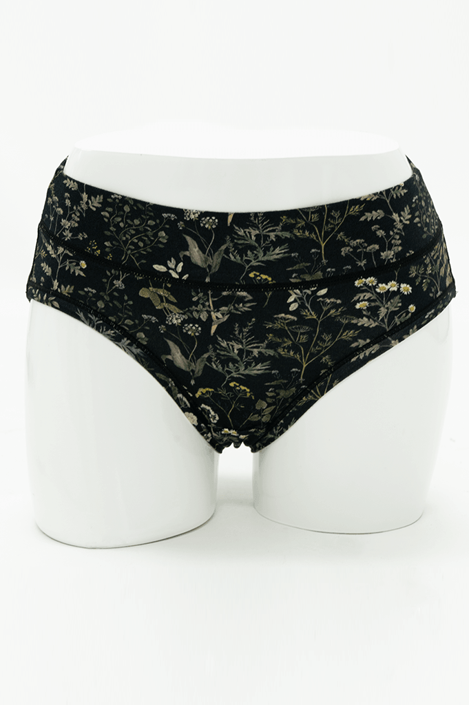 Front view of Meadow Black Hipster briefs with botanical print on mannequin