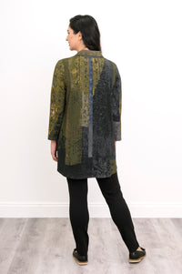 Back view of a patterned green knit top, showcasing a comfortable fit and hip-covering tunic length.