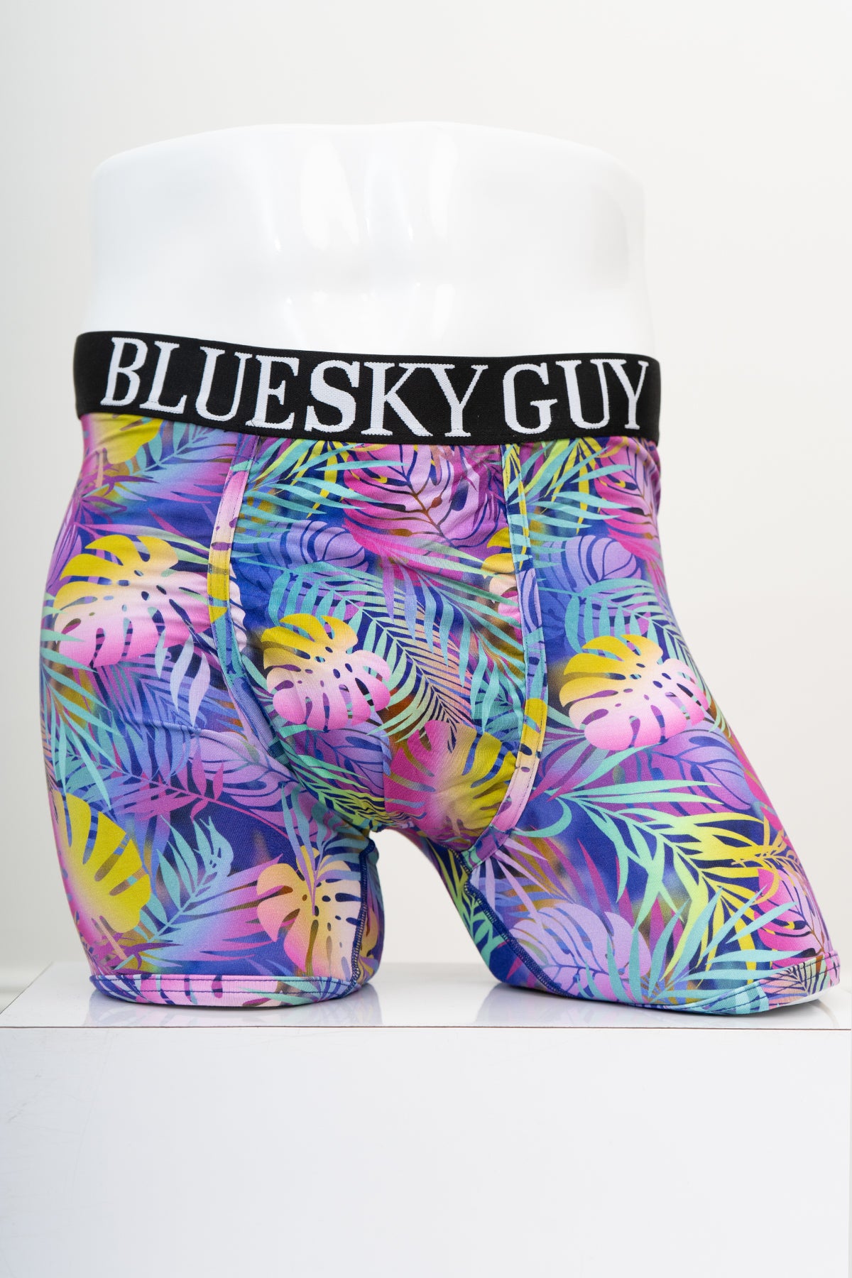 Front view of multicolour tropical leaf patterned men's underwear with an elastic waistband on a white background