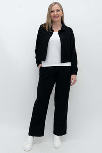 Model wearing black Melodie Pant with a white top and black jacket, front view