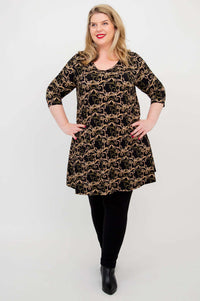 Model standing, wearing Veronica A-Line Tunic with black vine design and leggings