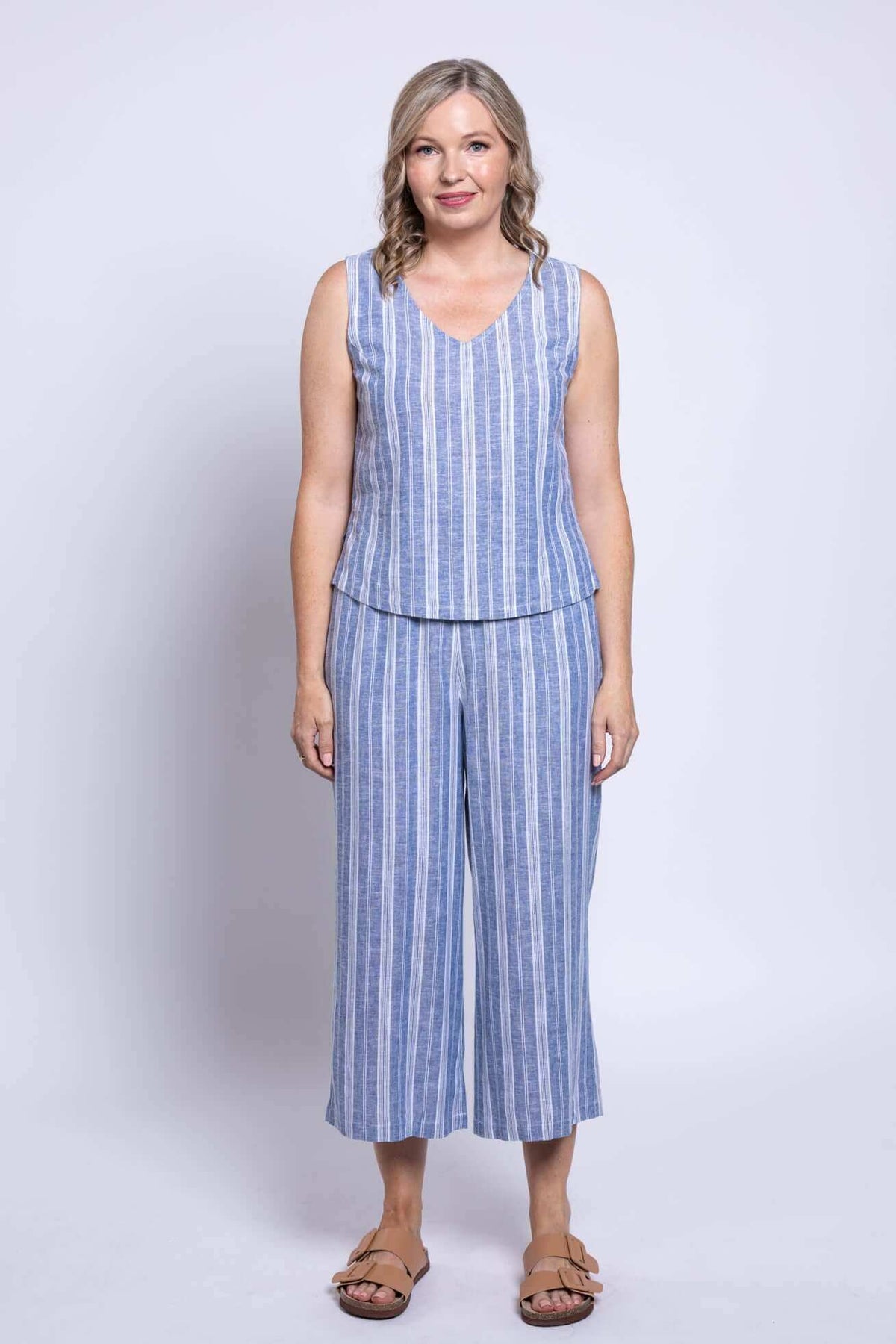 Model wearing Landon Capri Pants and matching blue stripe top, front view